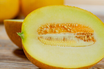 Juicy Yellow Melon Half with Seeds on Rustic Surface