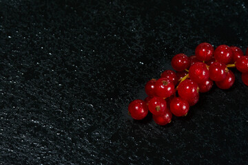 Dewy Red Currants on Black Stone Surface