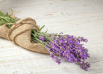 Freshly picked lavender bouquet arranged beautifully on a weathered wooden table