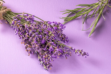 Vibrant lavender bouquet with green stems against a soft lavender background