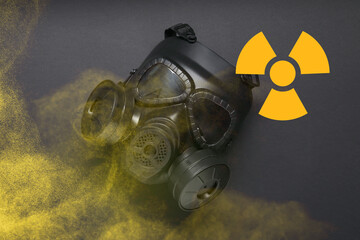 Radiation threat. Gas mask, radioactive sign and smoke on grey background, top view