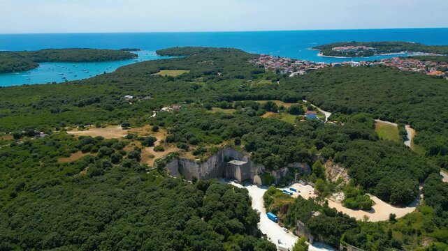 Ancient Roman quarry Cave Romane near Pula, Croatia &ndash; historic stone site surrounded by forest, dramatic rock formations