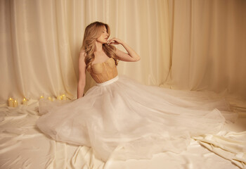 A woman in a flowing dress sits gracefully