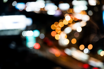 Night shows reflection from cars tail lights and street lighting on road. Abstract background for...