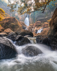 Cimarunjung Waterfall is a hidden gem, its crystal-clear waters cascading down a rugged rocky slope...
