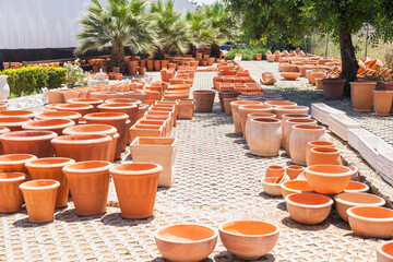  Outdoor display of terracotta pots in a sunny garden center