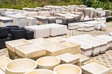 Stone and concrete garden pots arranged for sale