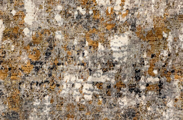 Close up of decorative carpet rug or fabric in random grunge and dirt texture. Golden brown, grey,...