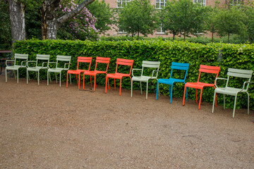 Multicolored chairs at Royal library Garden in Copenhagen, Denmark. Famous park in city center in...