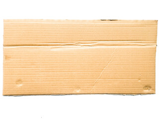A piece of cardboard with a textured striped pattern, kraft paper for wrapping on a white background. The edges of the cardboard are torn and wavy brown. Top view of recycled cardboard texture.