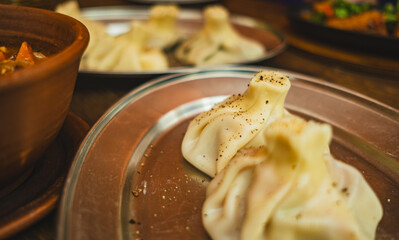 Delicious khinkali traditional Georgian dumplings filled with meat are beautifully arranged on a...