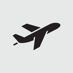 Silhouette of a jet airplane taking off against a light gray background