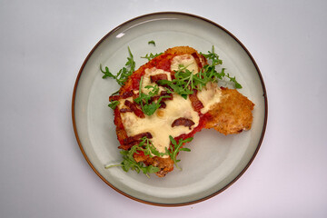 Deliciously Baked Chicken Dish Topped with Mozzarella, Bacon, and Fresh Arugula, Perfectly Layered for a Mouthwatering Meal Experience