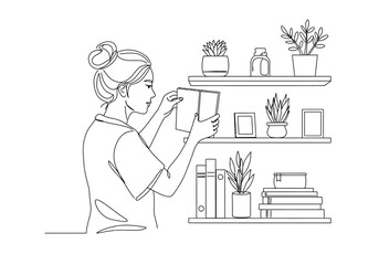 Line art illustration of a woman placing a book on a shelf with plants, picture frames, and other books.