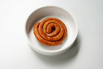Spiral Hard Candy Snacks on White Plate, Isolated Background