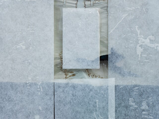 A closed storefront window covered with semi-transparent, frosted paper sheets. The glass is fully concealed from the inside