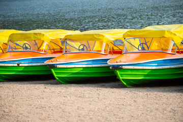 small yellow pleasure motor boats at shore at the lake resort