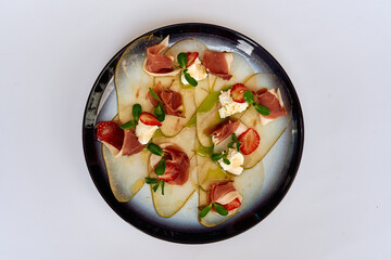 Deliciously Crafted Gourmet Dish Featuring Delicate Slices of Prosciutto with Fresh Strawberries...