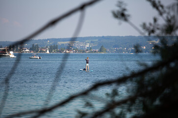 unrecognisable person on sup board on the lake
