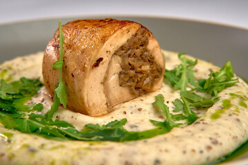 An Exquisite Culinary Creation Showcasing Tender Meat Rolled with Savory Filling, Served on a...