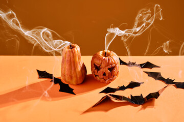 Halloween-style candles on a orange background. Festive decor.