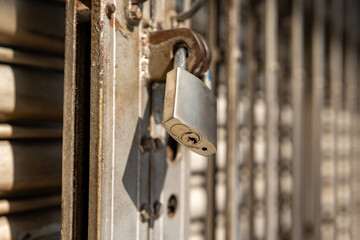 Weathered Padlock on Rusty Metal Gate