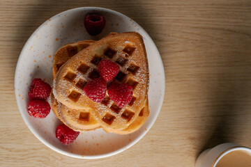top-down view of heart-shaped waffles and coffee