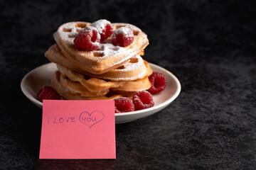 Heart waffles with raspberries and "I love you" note