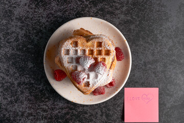 Top view of heart waffles with "I love you" note