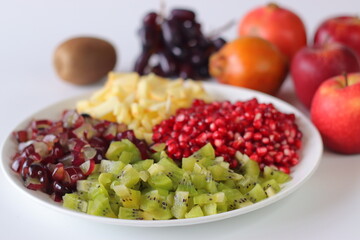 Fruit Platter. Vibrant fruit plate with pomegranate seeds, diced kiwi, grapes and apples
