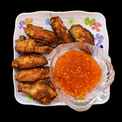 fried chicken on the plate with dipping sauce is ready to eat.