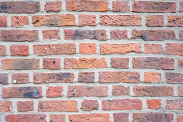 Stone wall with much brown bricks of the modern building.