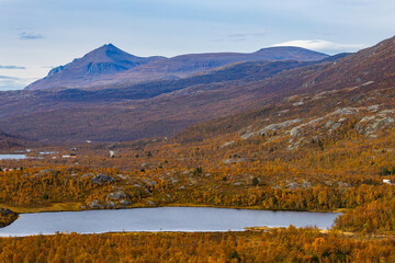 Autumn landscape of Kilpisjarvi, Finland, showcasing colorful foliage, serene lakes, and majestic...