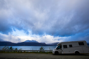 A motorhome parked by the road in the autumn landscape of the Lyngen Alps, Northern Norway, with...