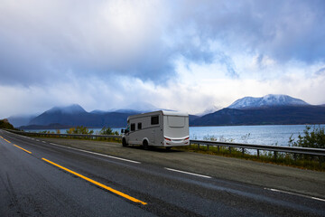 A motorhome parked by the road in the autumn landscape of the Lyngen Alps, Northern Norway, with...