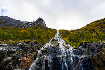 Autumn landscape of Senja Island in Northern Norway with colorful foliage, mountains, and a serene...