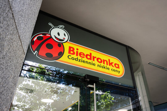 Biedronka supermarket entrance in Warsaw, Poland with clear signage and lights