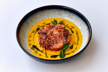 A Delicate Culinary Creation Featuring a Vibrant Sauce, Garnished with Fresh Mint and Tasty Ingredients in a Rustic Bowl Design