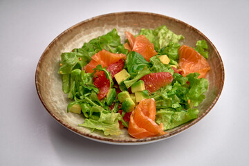 Fresh and Colorful Salad Featuring Leafy Greens, Avocado, Grapefruit, and Salmon for a Healthy and Delicious Meal Option
