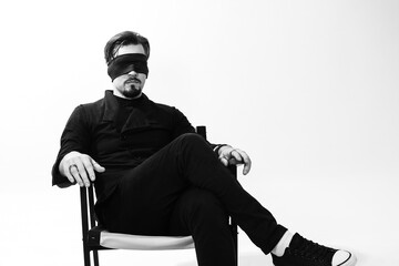 A man with his eyes blindfolded. Studio photo