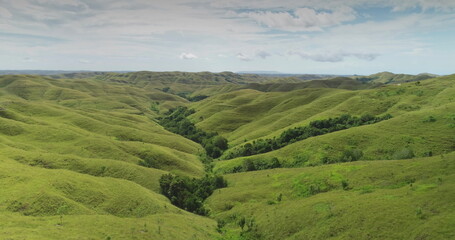 Aerial drone footage captures the breathtaking landscape of Sumba island, Indonesia, showcasing...