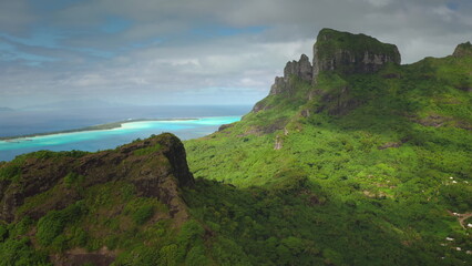Stunning landscape highlighting vibrant green mountain terrain overlooking a striking blue lagoon...