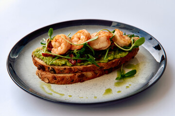 Savory Avocado Toast with Succulent Shrimp and Fresh Microgreens on Artisan Bread, Drizzled with Olive Oil for a Perfect Gourmet Experience