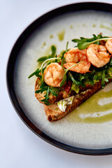 Delicious Open-Faced Shrimp Sandwich with Fresh Arugula on Whole Grain Bread, Drizzled with a Flavorful Olive Oil Dressing