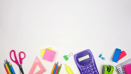 Colorful school supplies moving bottom border. Above view stop motion loop video over a white background. Back to school concept. - Powered by Adobe