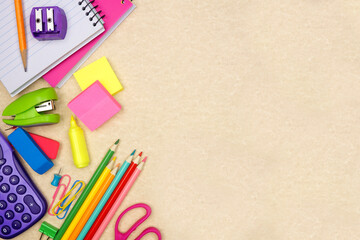 School supplies side border. Top down view on a brown paper background. Copy space. Back to school...