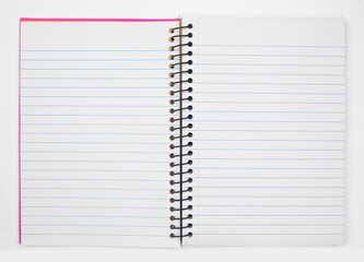Open coil notebook with blank lined paper pages over a white background. Copy space.