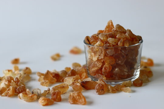 Gond Katira or Gum arabic crystals, also known as edible gum or gond, in a clear glass container