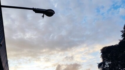 street lights with a cloudy sky background in the afternoon
