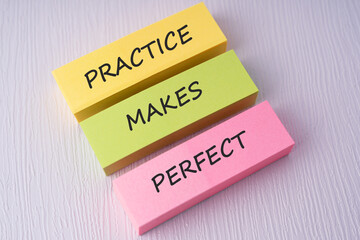 Colorful sticky notes with text practice makes perfect on white background